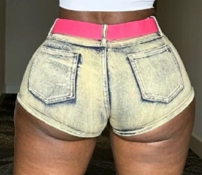 Low waisted washed denim mini skort w/pockets & pink belt as pictured