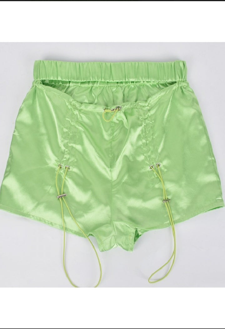 Lime green satin ruched short shorts.